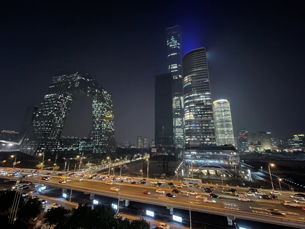 Views of the Guomao skyline in Beijing with the iconic CCTV Tower at night, captured from the China World Mall terrace.
